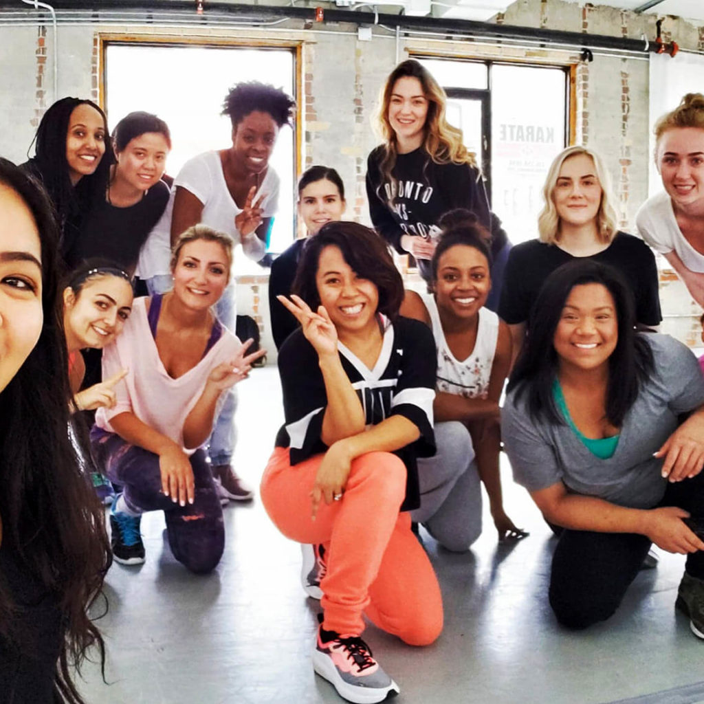 Janet posing with a group of dancers